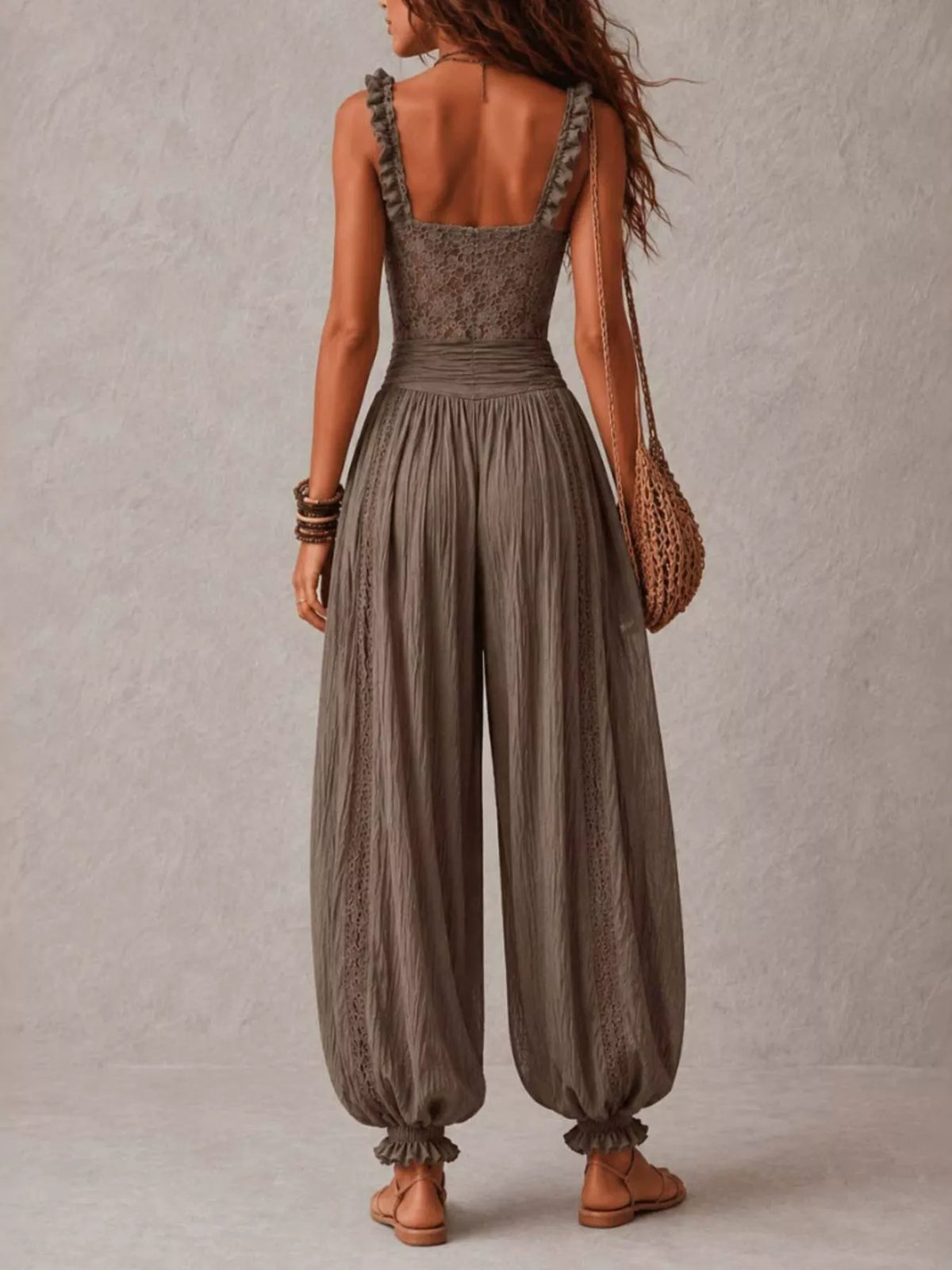 Dark gray lace corset jumpsuit with smocked waist and flowy harem pants