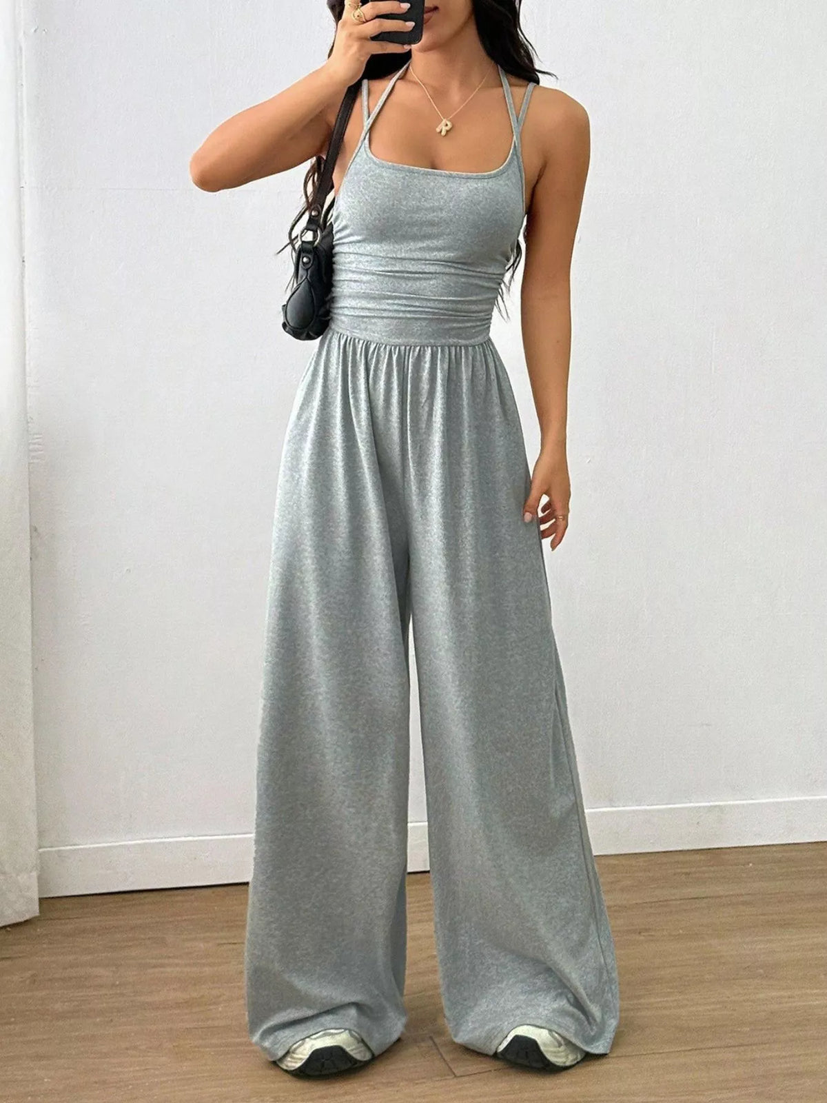 Light gray spaghetti-strap wide-leg jumpsuit with scoop neckline and gathered waist