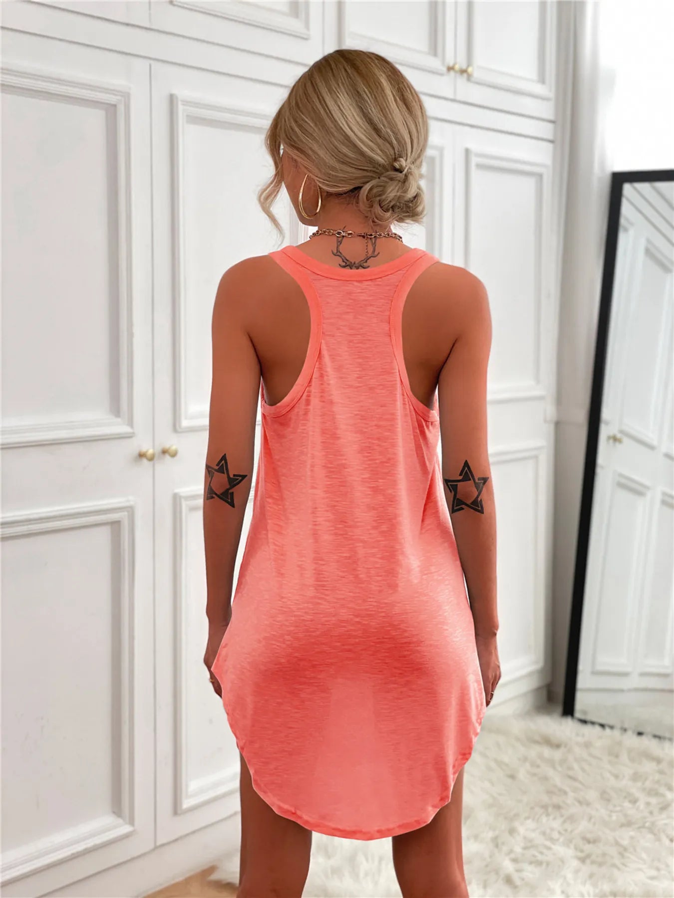 Casual Tank Mini Dress in coral pink with curved hem, back view.
