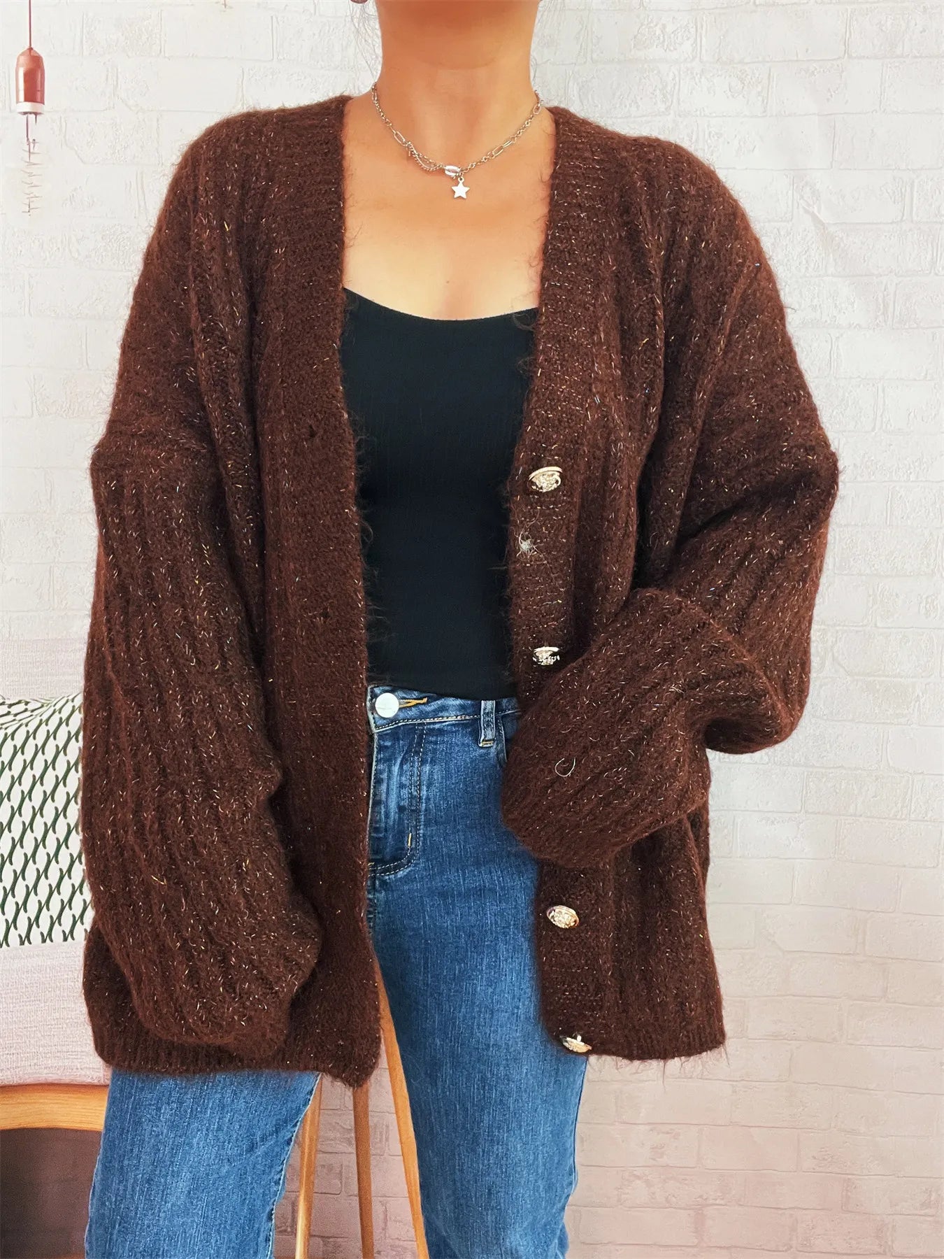 Brown cable-knit cardigan with V-neckline, gold-tone buttons, and long sleeves