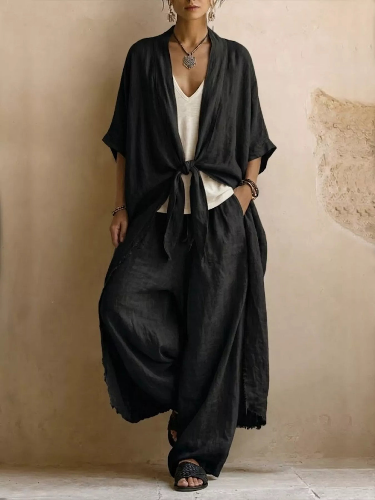 Black tie-front cardigan and wide-leg pants set, tied waist detail.