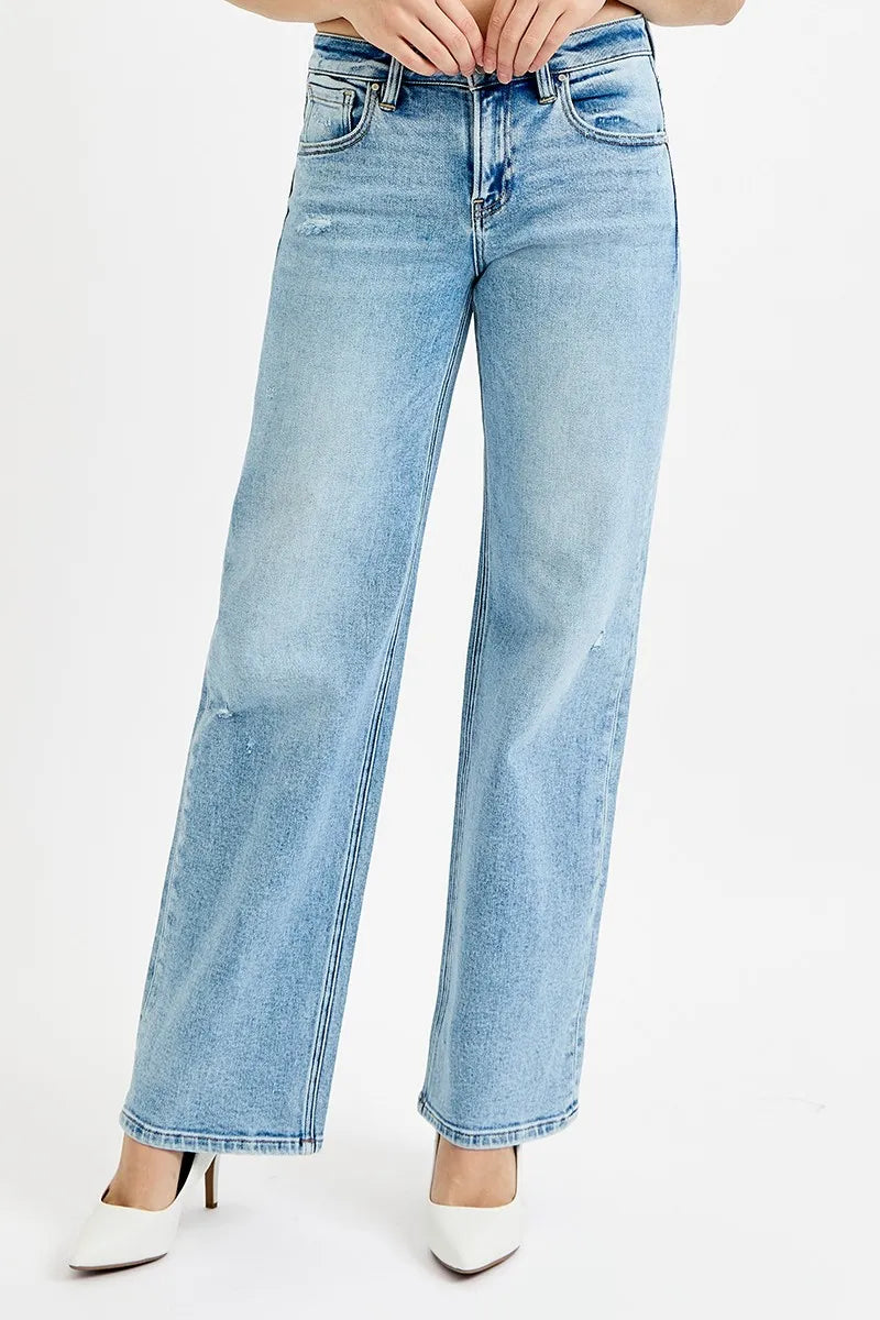 Medium-wash low-rise boyfriend jeans, ankle length, front view with hands at waistband