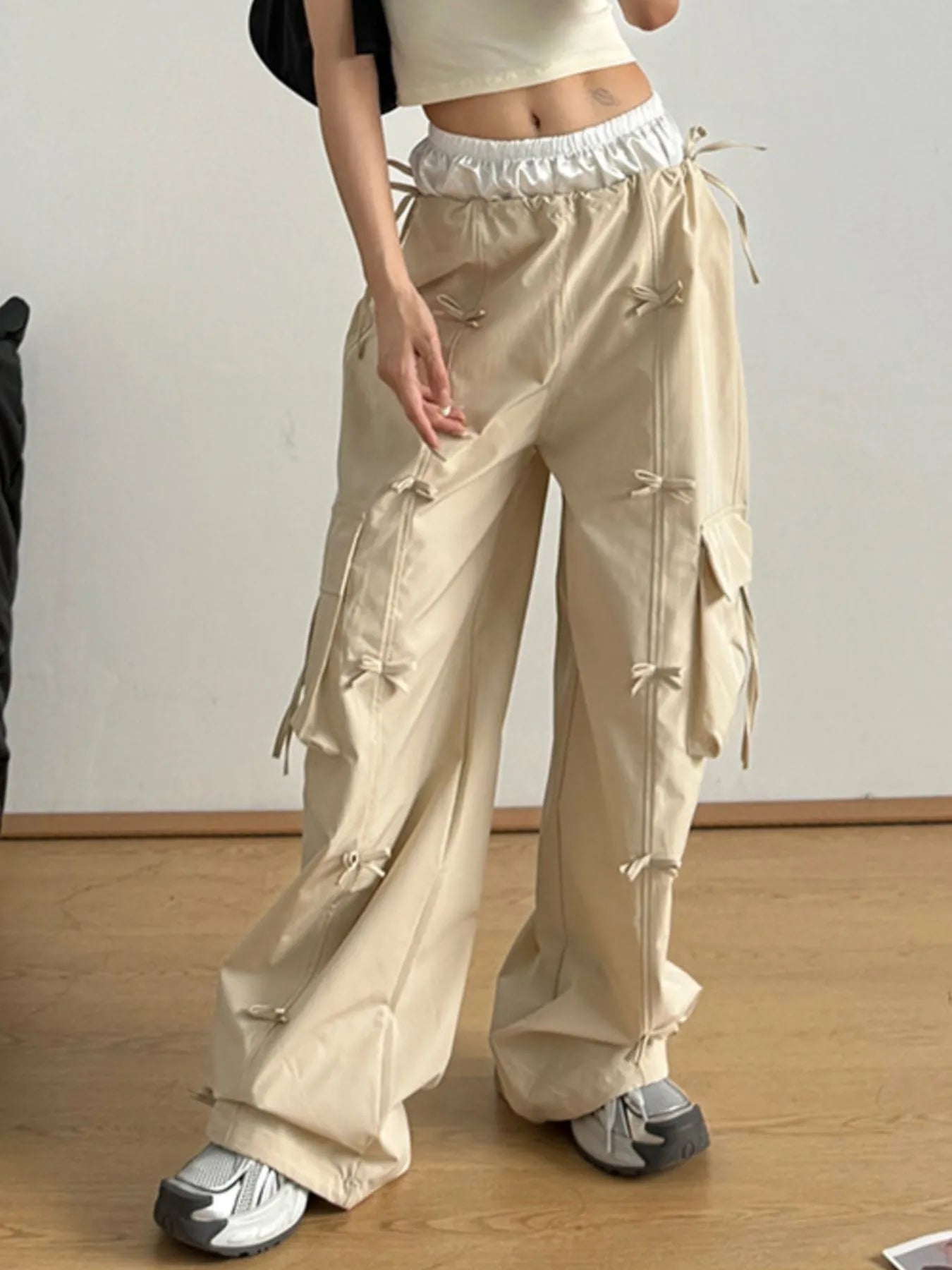 Tan cargo pants with bow-tie drawcords, elastic waist, and roomy relaxed legs
