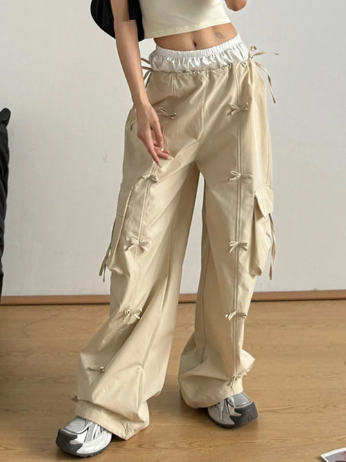 Tan cargo pants with bow-tie drawcords, elastic waist, and roomy relaxed legs