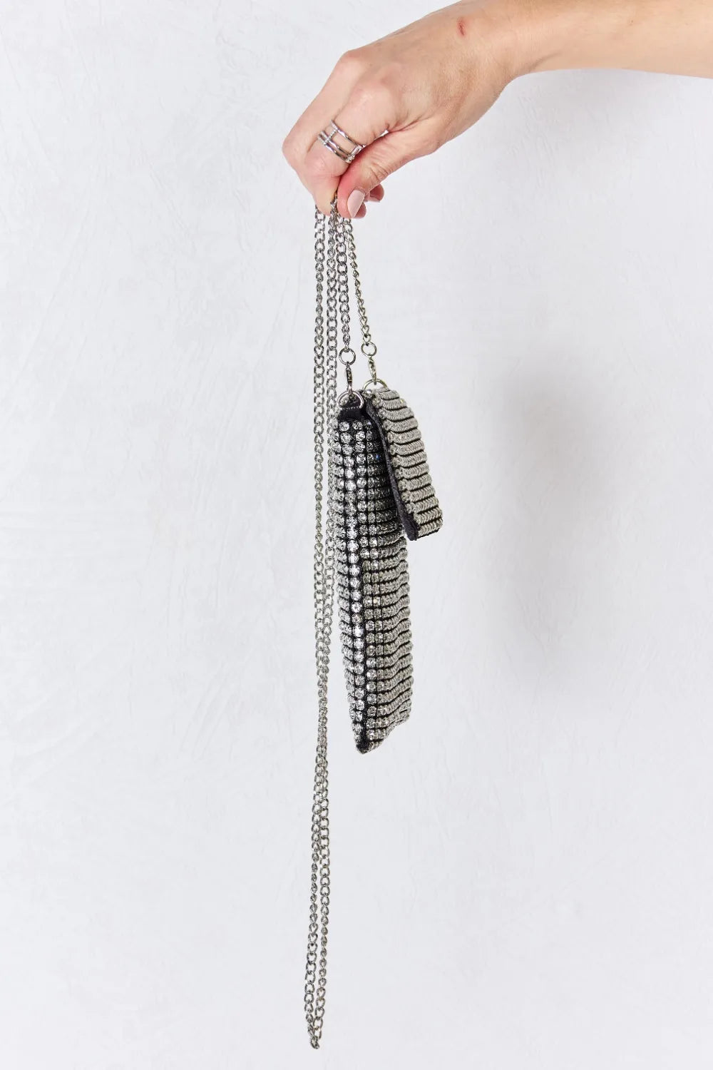 Rhinestone mini crossbody bag with silver chain strap and textured side detail
