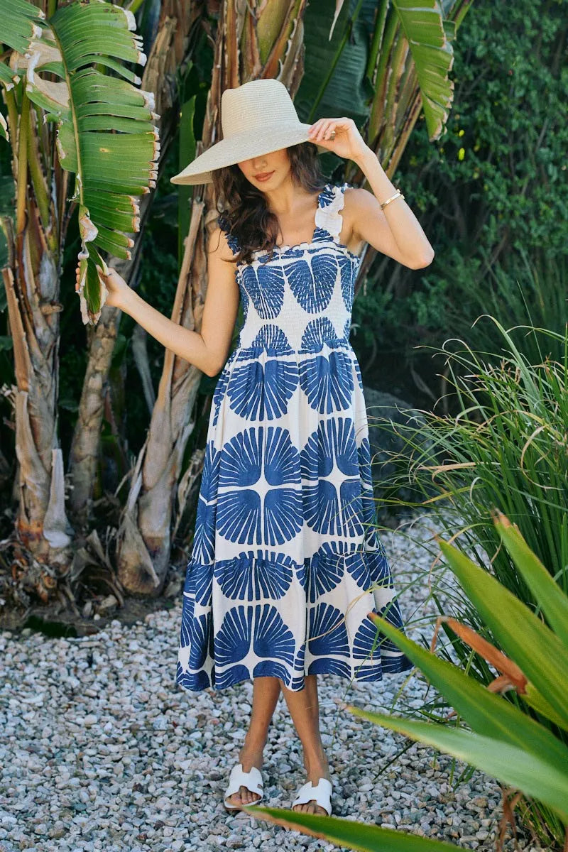 Tiered midi dress with smocked bodice and navy abstract fan print on white, sleeveless