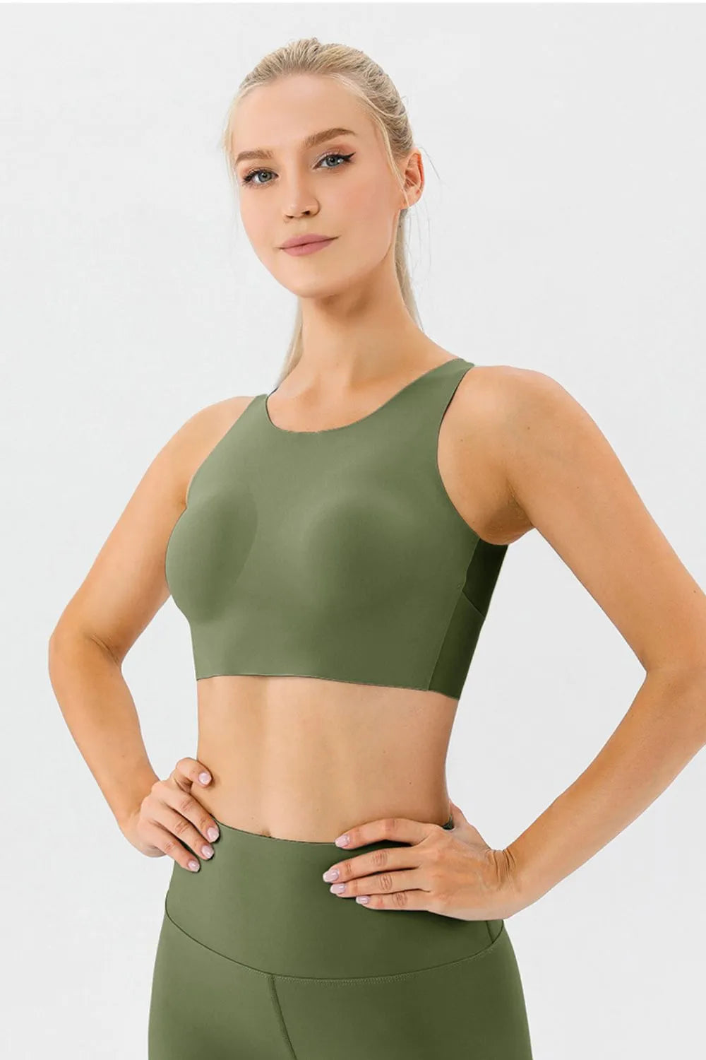 Green active bra with round neckline and wide straps, front view