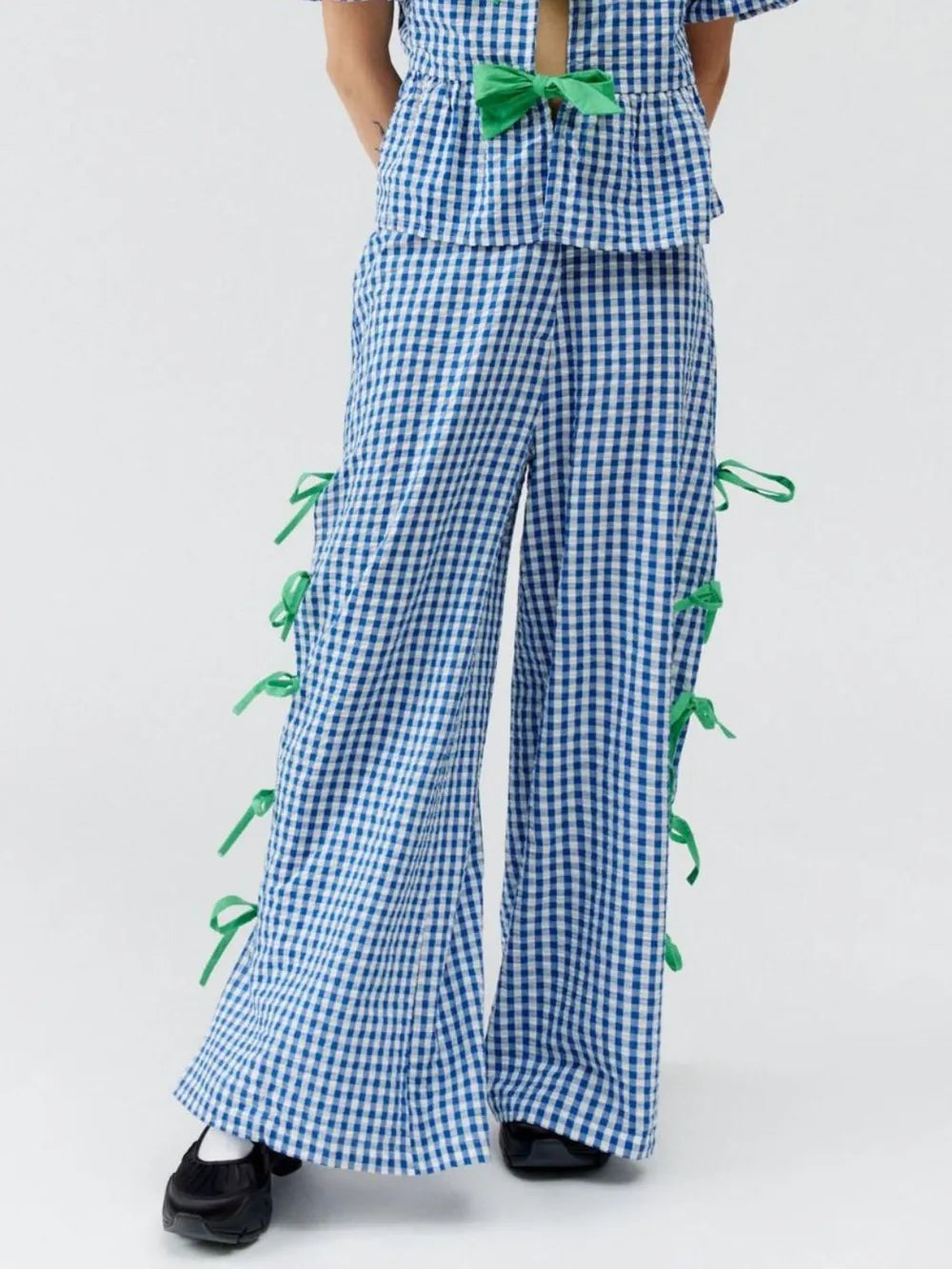 Blue gingham plaid pants with green side ties and wide-leg flares