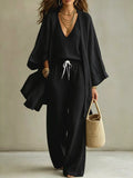 Black three-piece set with V-neck top, drawstring wide-leg pants, and open cardigan