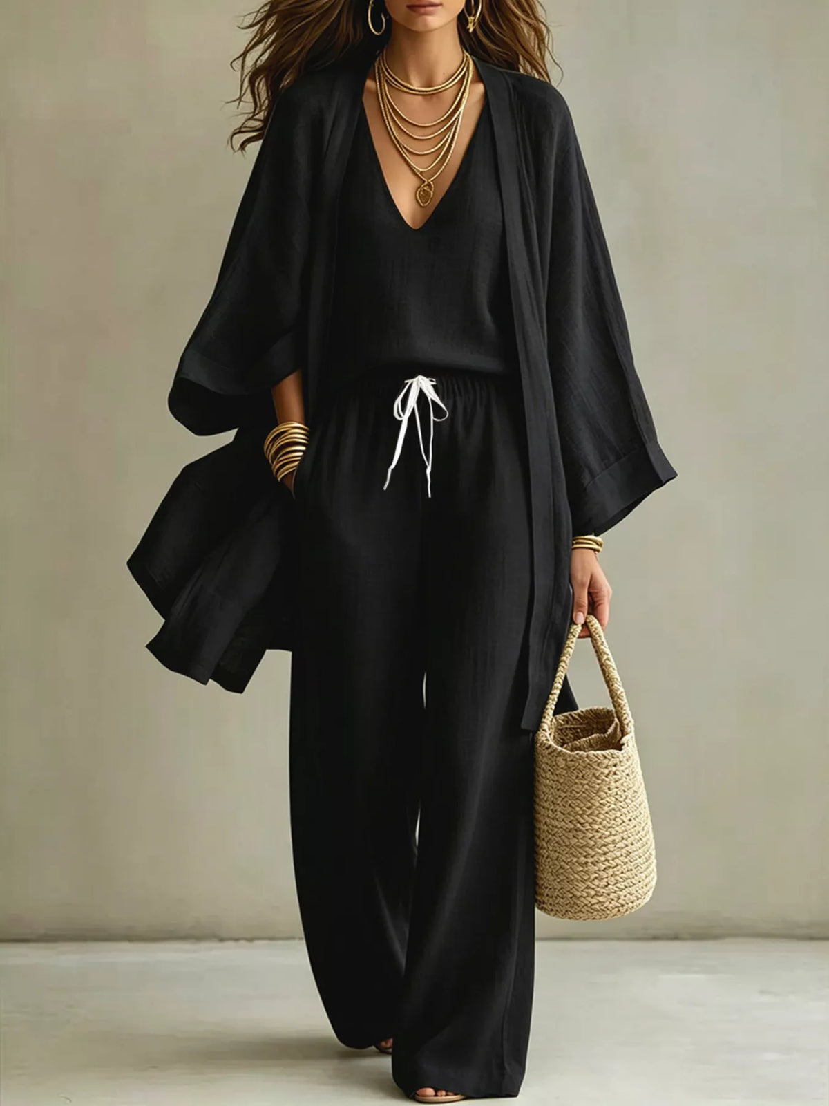 Black three-piece set with V-neck top, drawstring wide-leg pants, and open cardigan