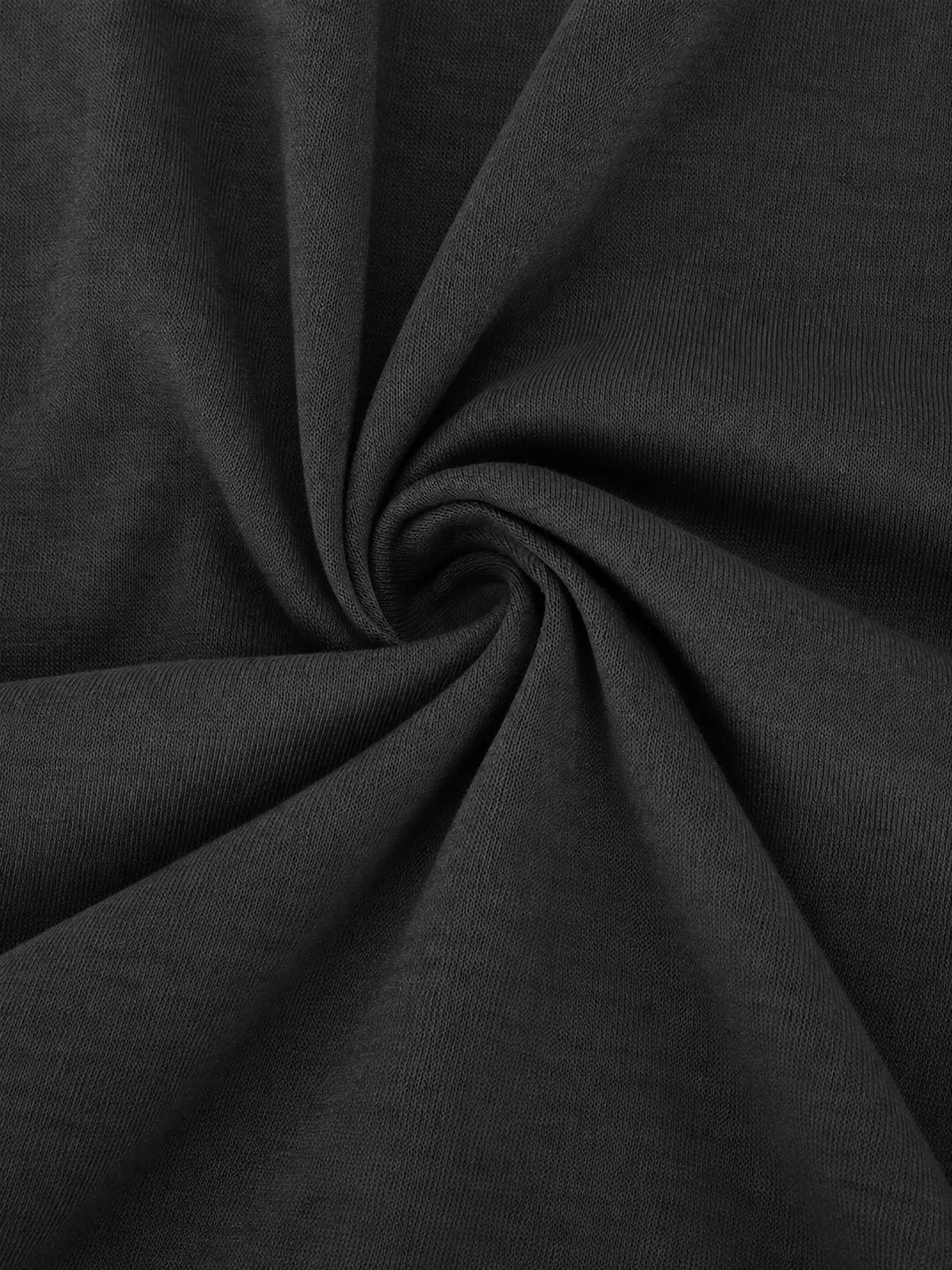 Close-up of dark textured fabric with soft drape and stitched grain