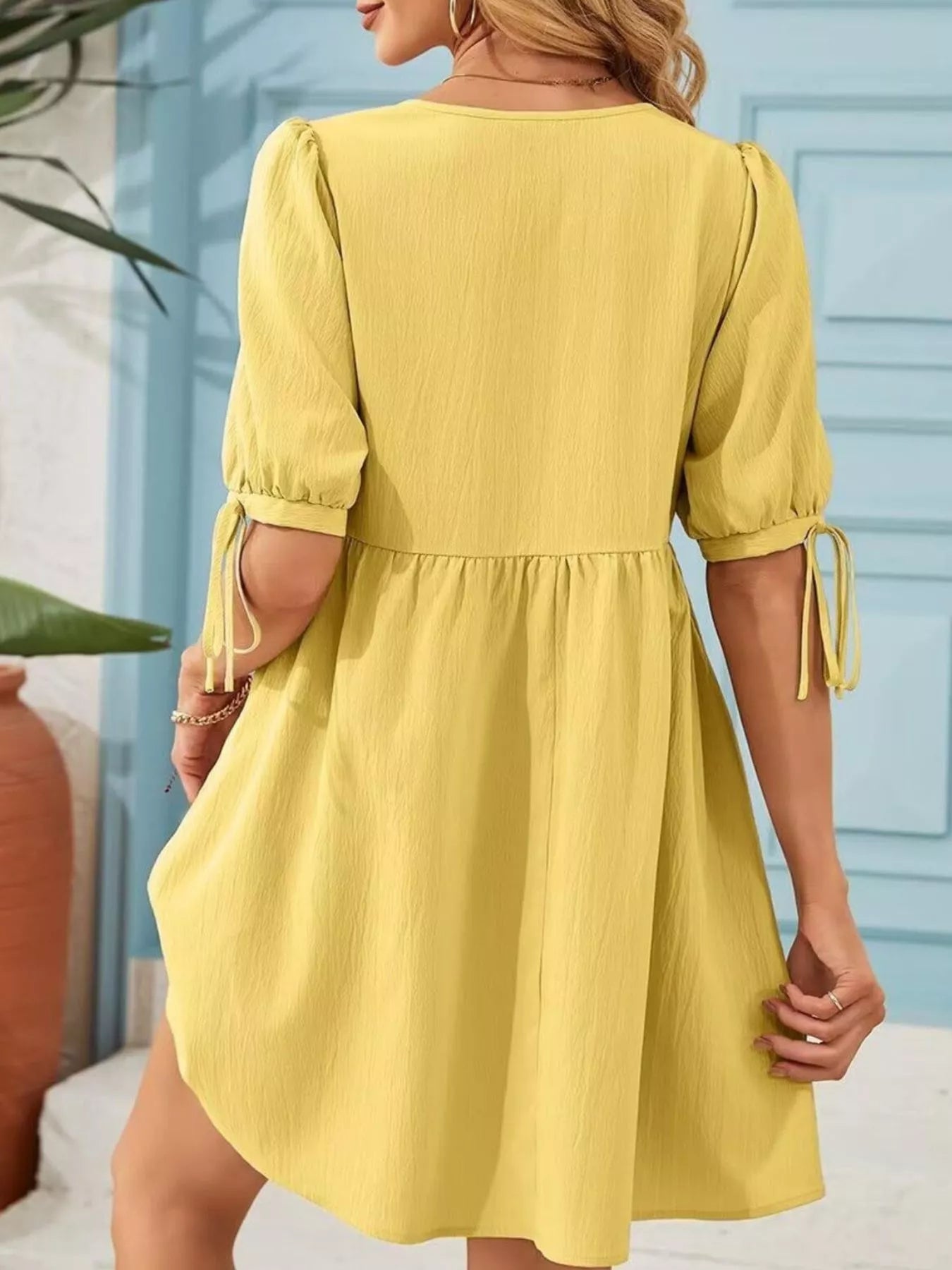 Tie-Neck Puff Sleeve A-Line Mini Dress in yellow, back view with gathered waist and tie-cuff sleeves.