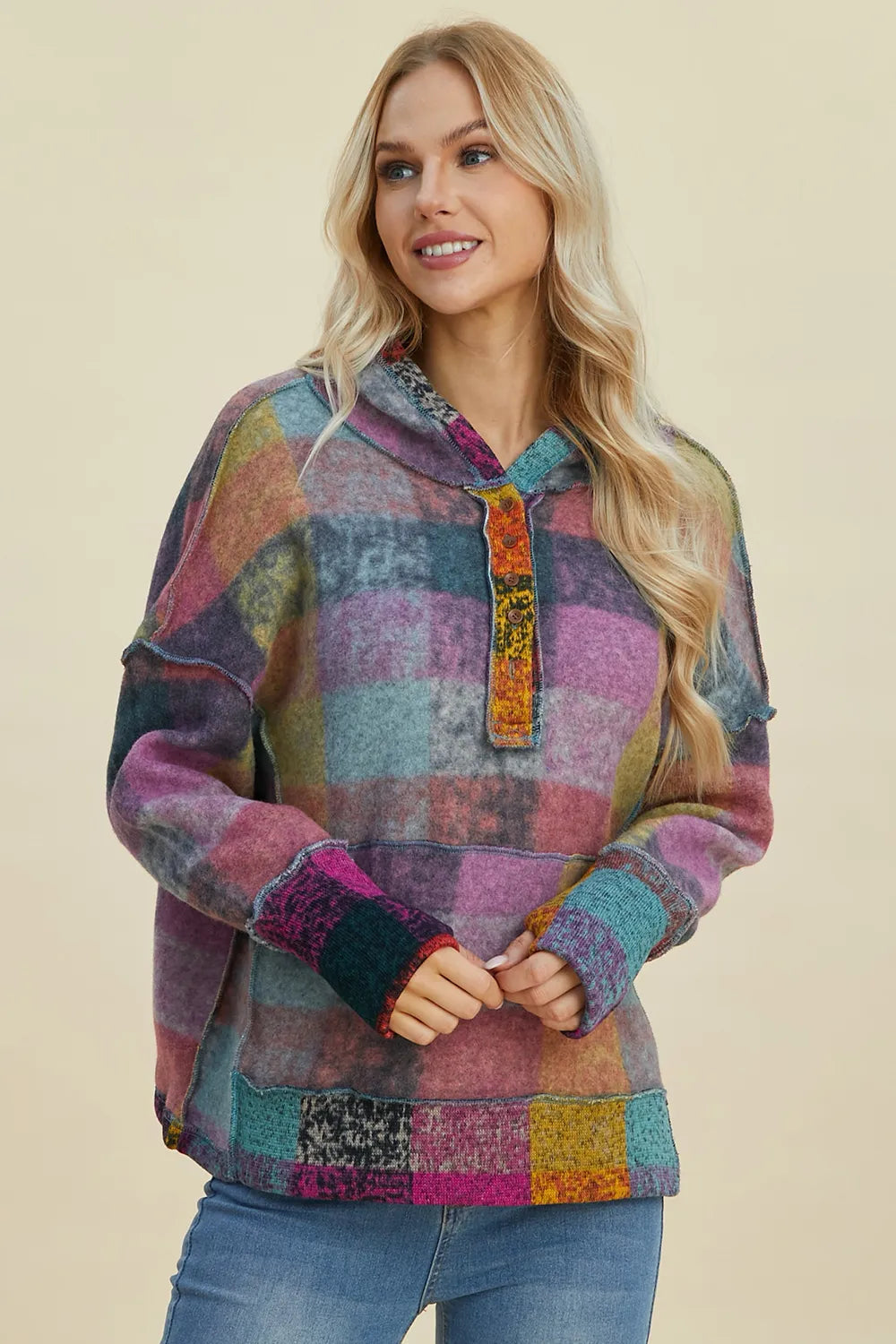 Plaid fleece hoodie with dropped shoulders, hood and quarter-zip placket, colorful purple tones.