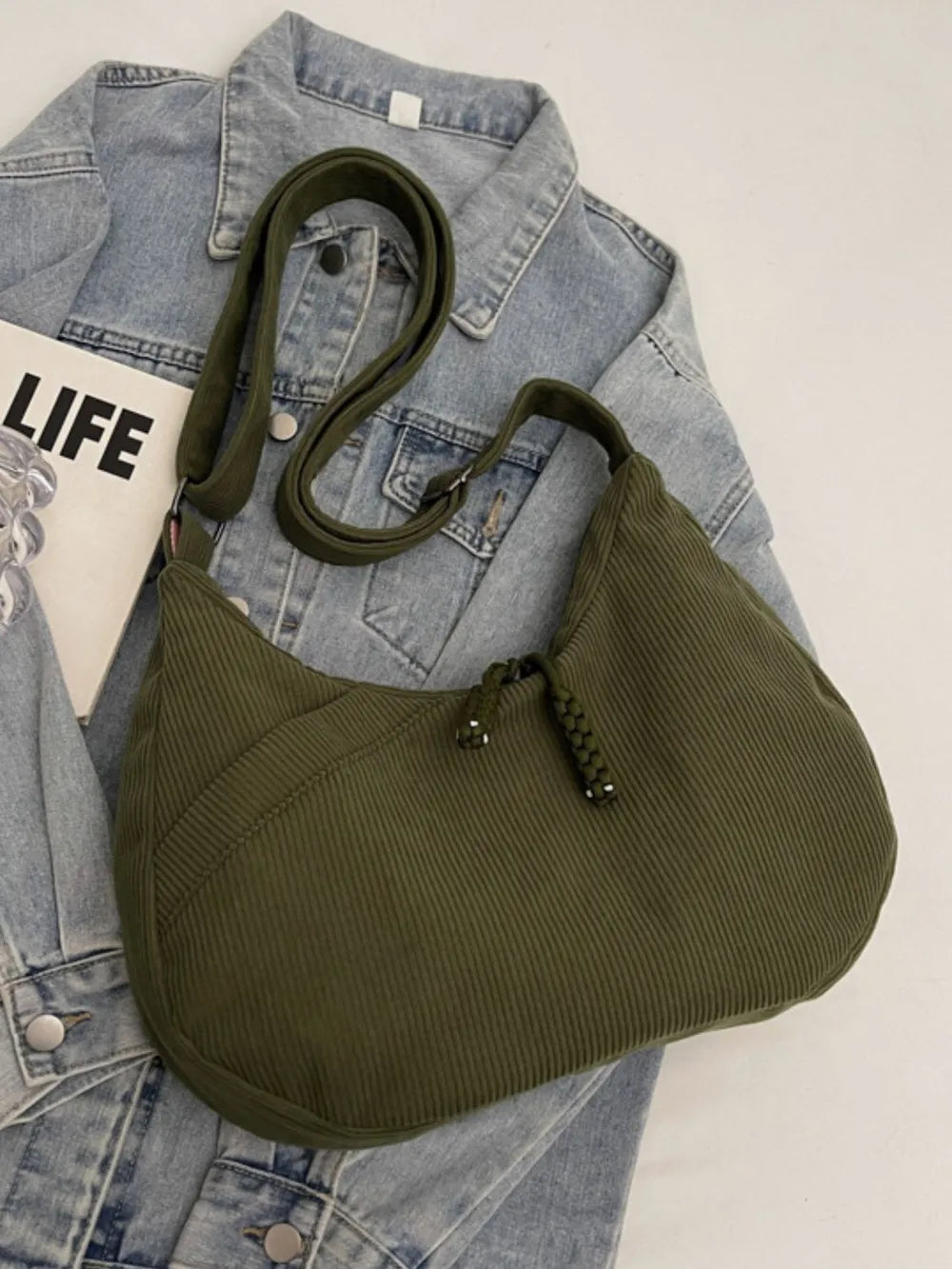 Moss green ribbed hobo shoulder bag with adjustable strap and braided tassel pull
