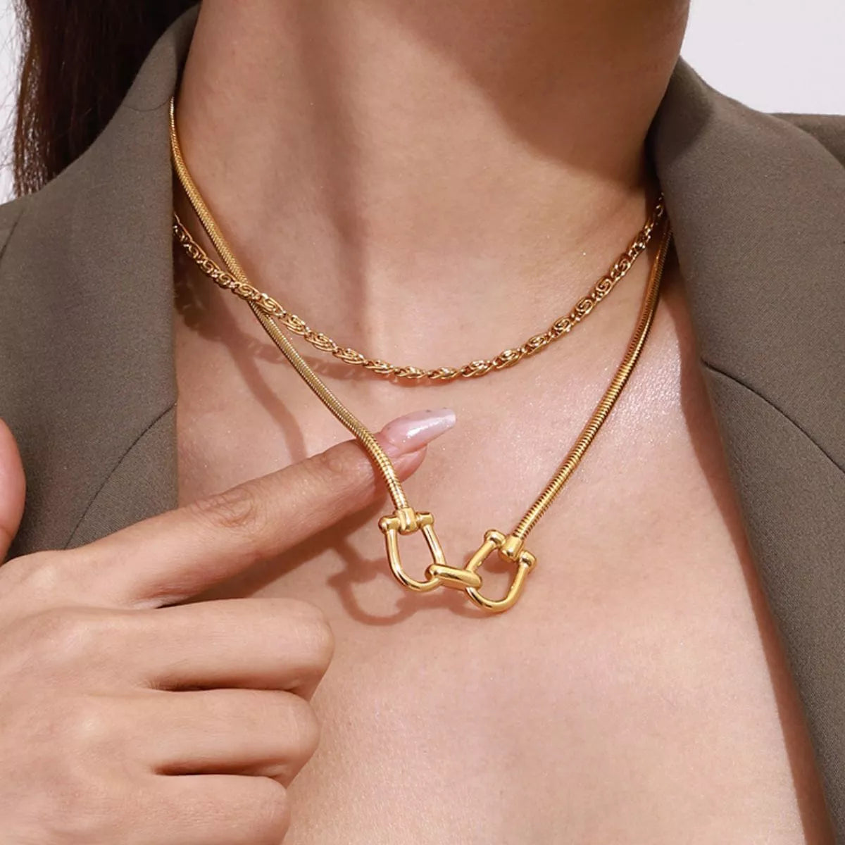 Gold-plated horseshoe necklace with linked U-shaped centerpiece and rope chain layers