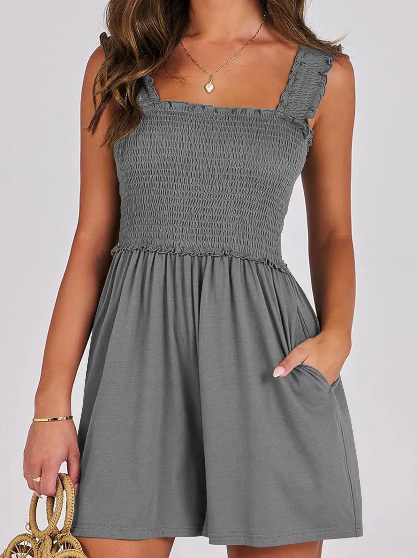 Dark gray smocked square-neck summer romper, sleeveless with ruffled shoulders