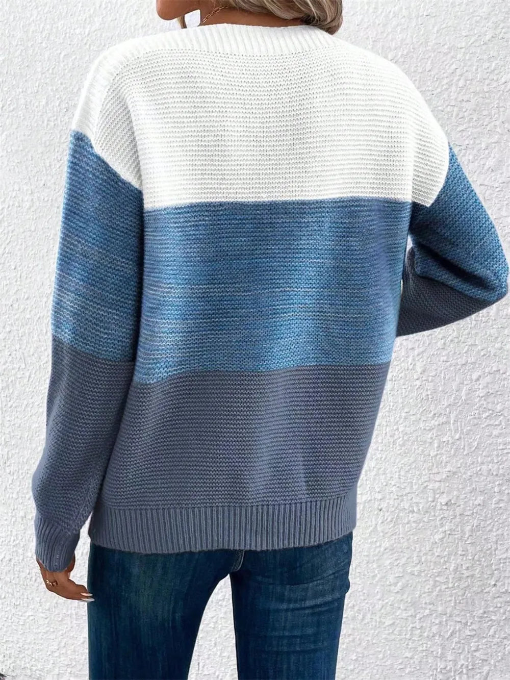 Back view of color-block long sleeve sweater in white and blue knit horizontal stripes