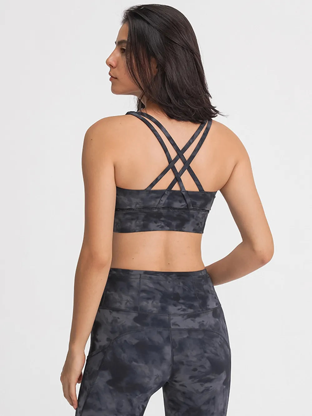 Scoop neck active tank top in dark camouflage print with crisscross open back straps