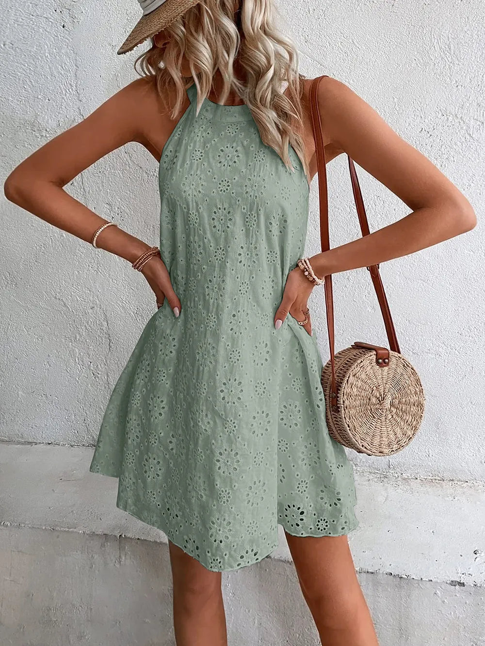 Sage green eyelet mini dress with halter neckline and flared knee-length hem