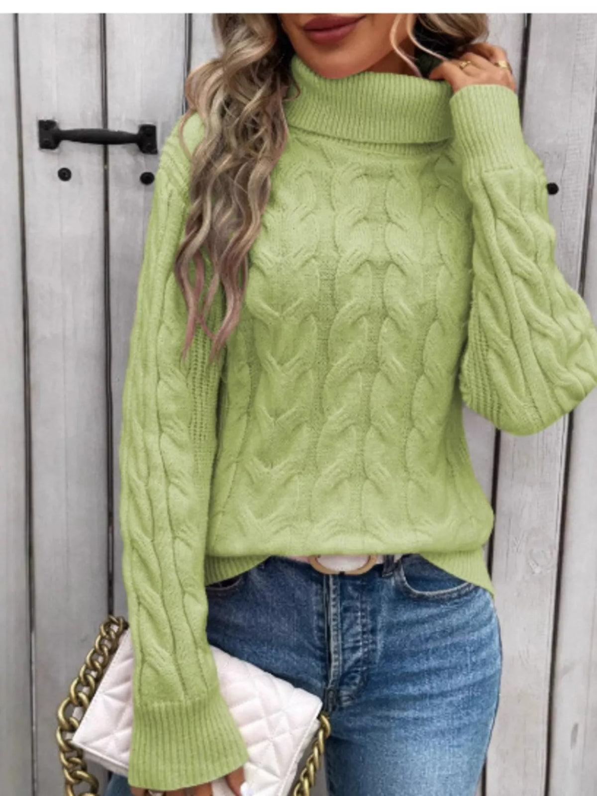 Light green cable knit turtleneck sweater with long sleeves and ribbed cuffs