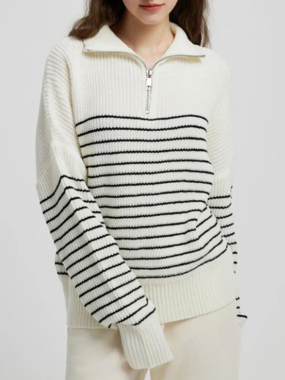 Cream striped half-zip knit sweater with long sleeves, black stripe bands across chest