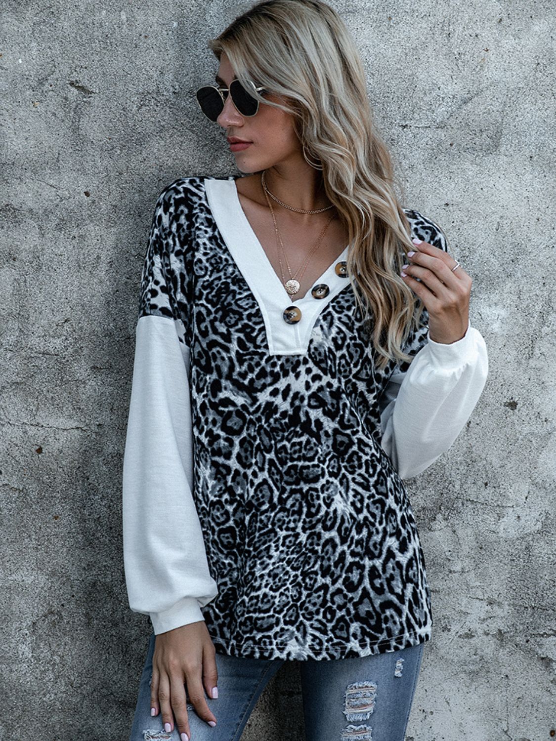 Leopard print V-neck top with white long sleeves and gold-tone center button