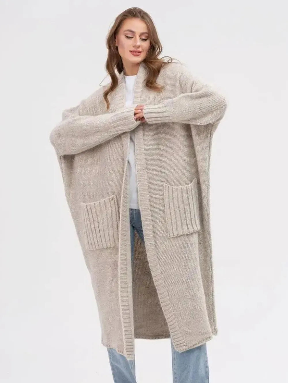 Beige longline open-front cardigan with two patch pockets and ribbed trim
