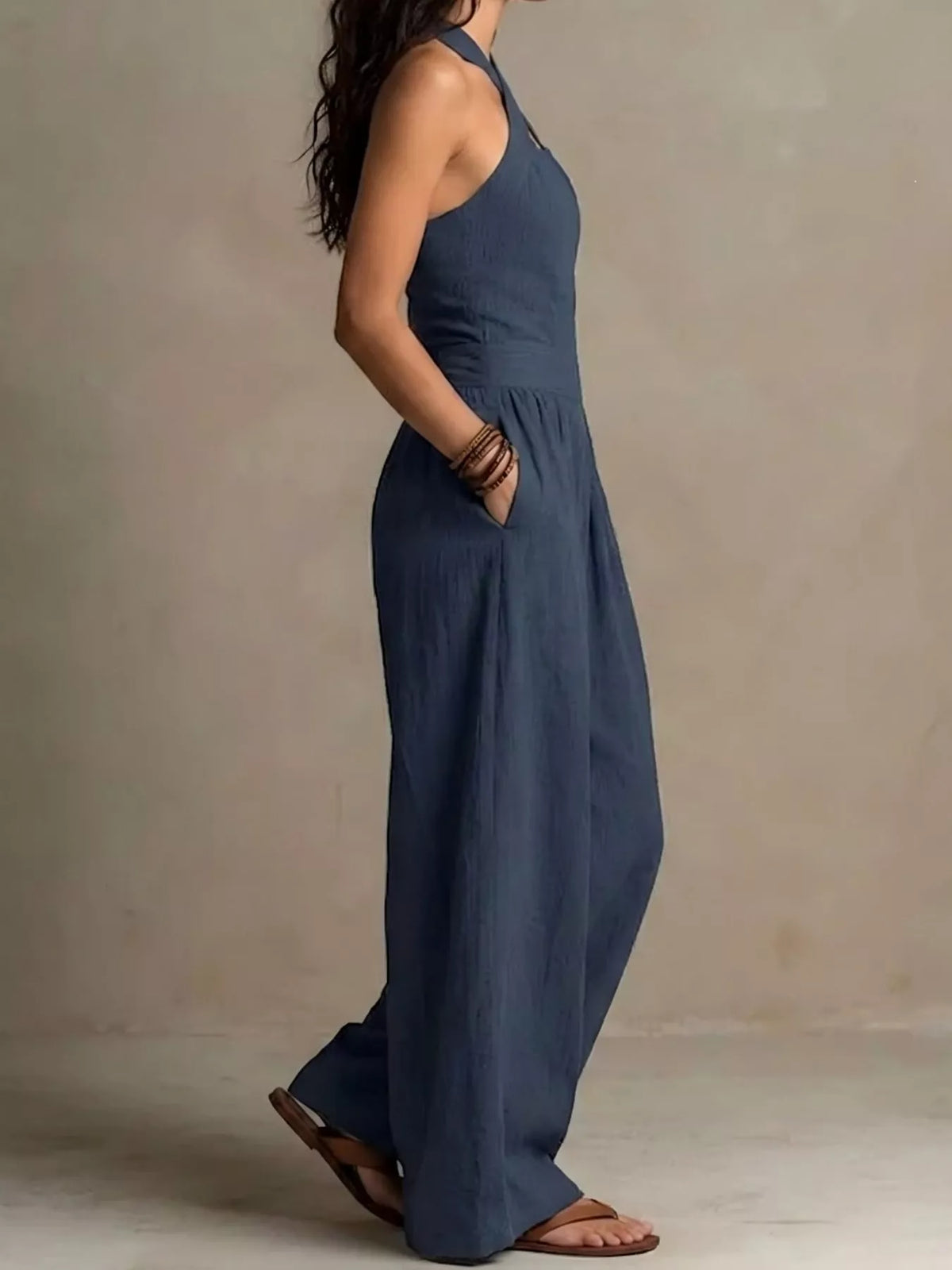 Navy halter linen jumpsuit with open neckline strap, high waist, wide legs