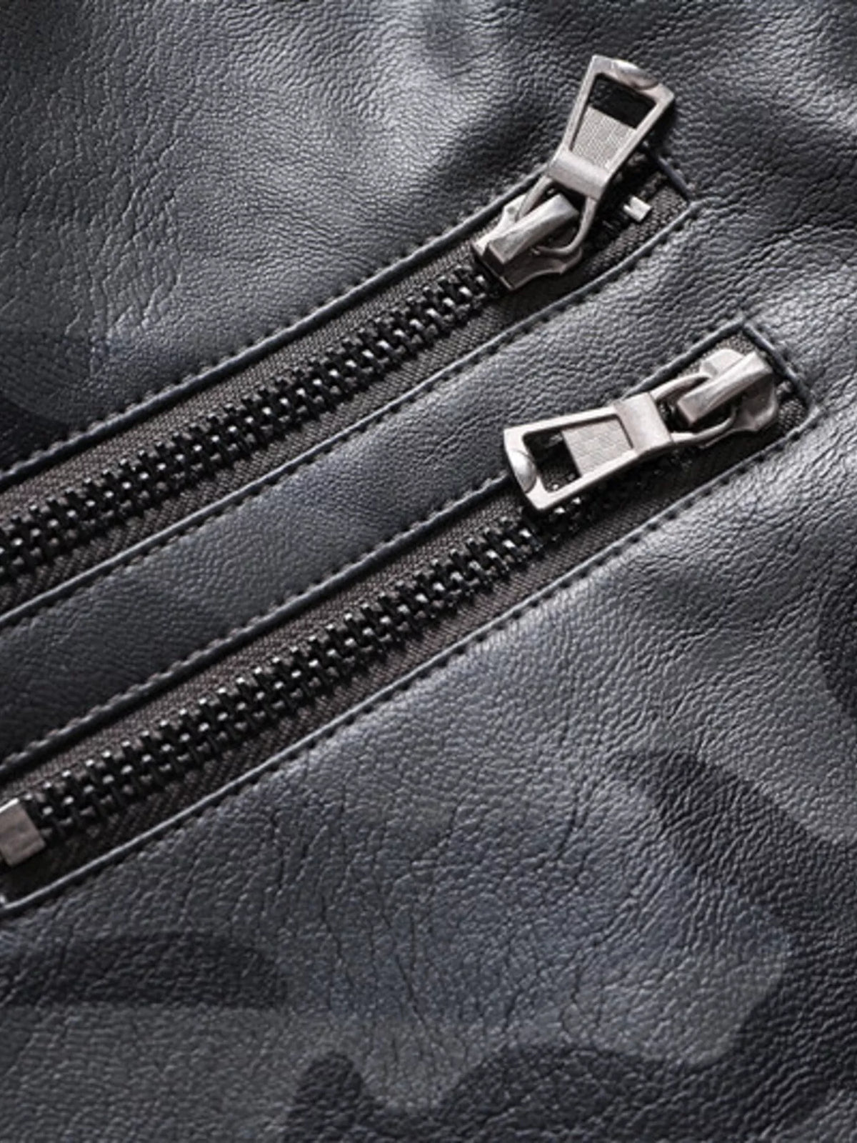 Vegan leather jacket close-up of dual zippers with metal pulls