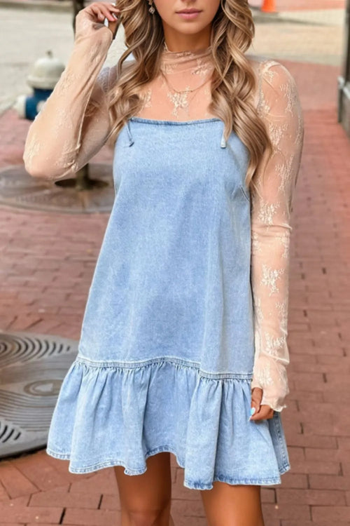 Light blue denim spaghetti strap dress with bow detail and ruffle hem, worn with long sleeves