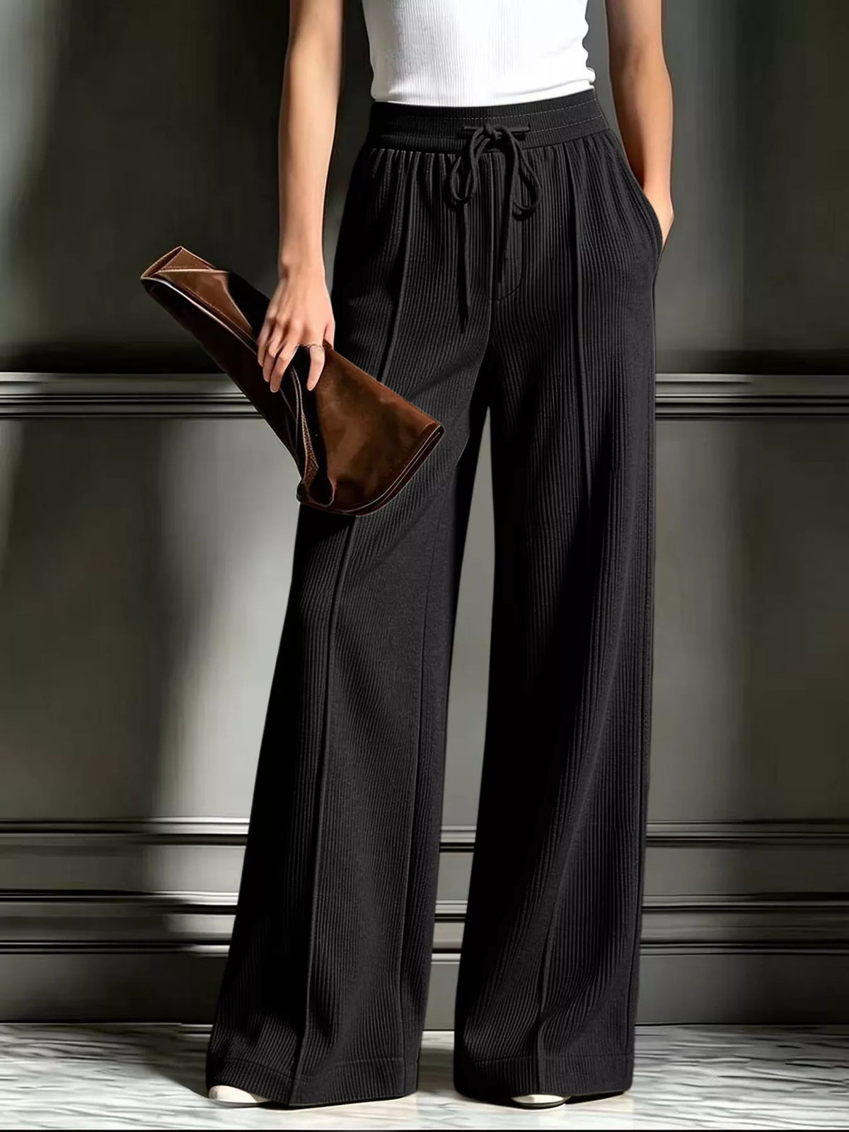High-waisted wide-leg ribbed corduroy pants in black with drawstring waist