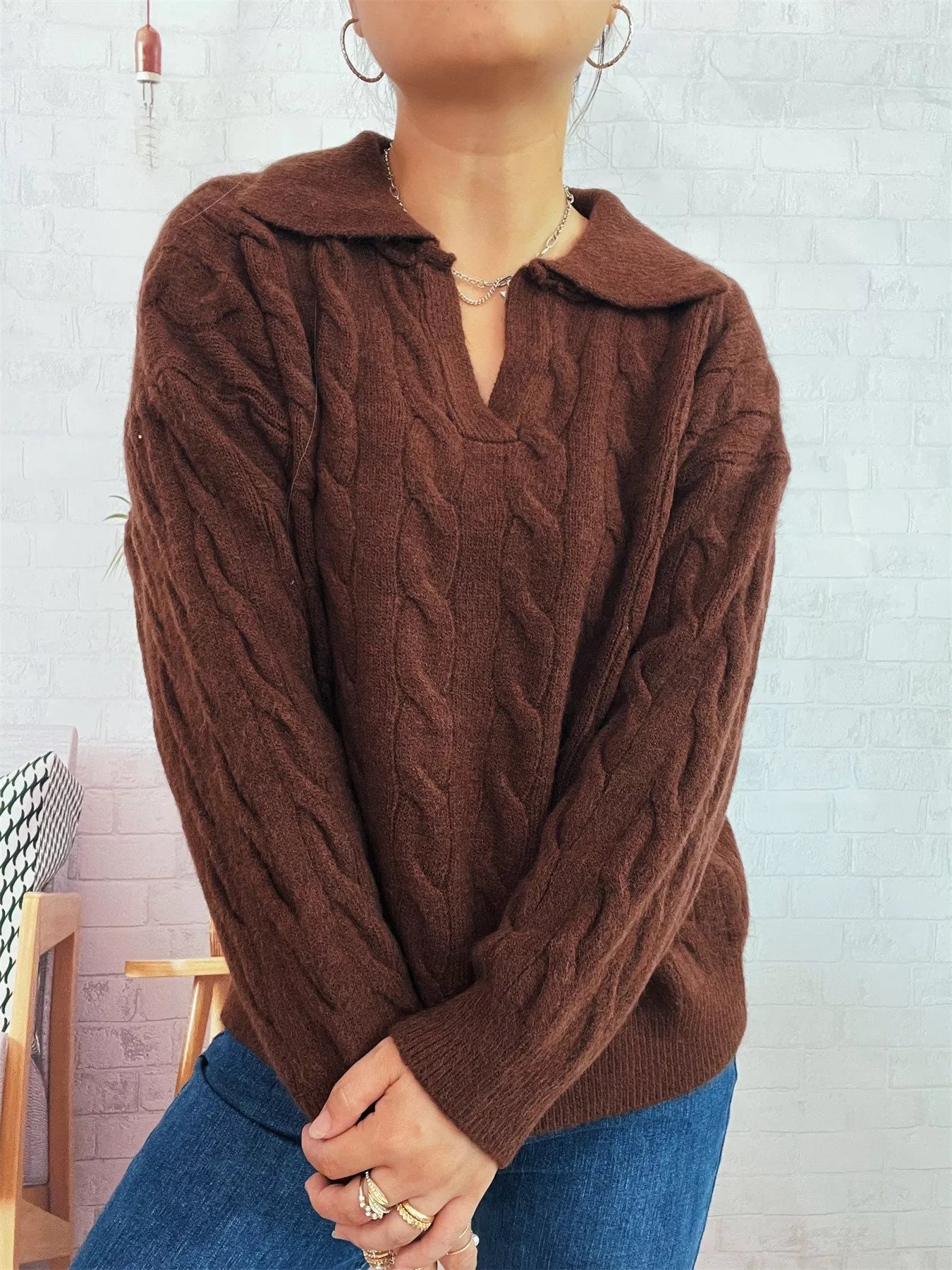 Brown cable knit Johnny-collar sweater with raised cable texture and long sleeves