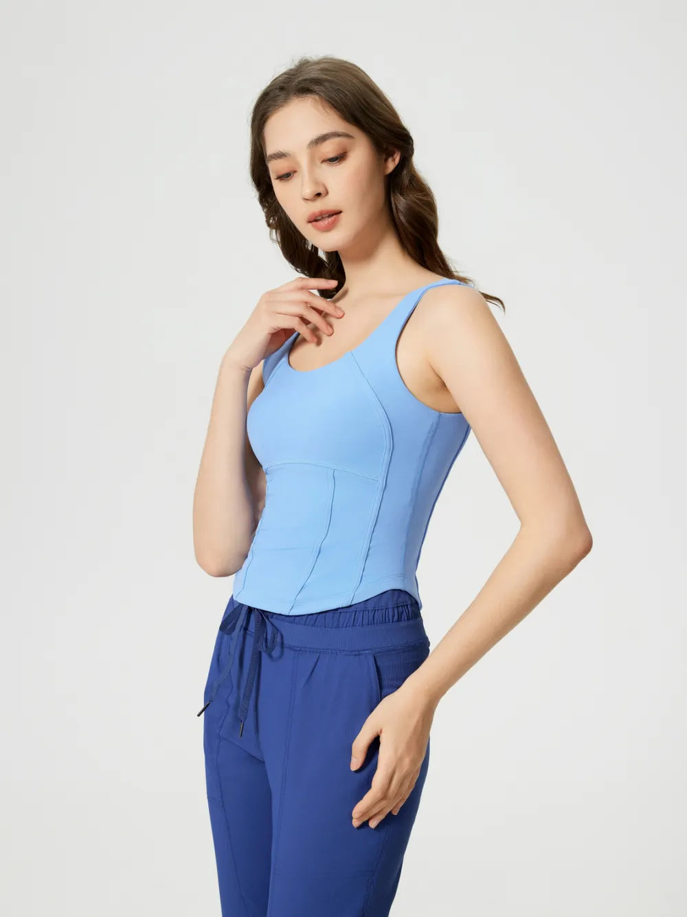Light blue active tank with wide straps and curved stitched bust panels
