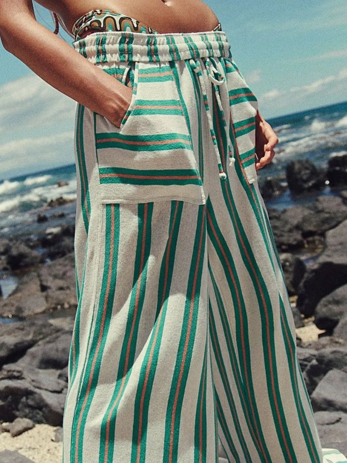 Wide-leg drawstring pants with green vertical stripes and gathered waist