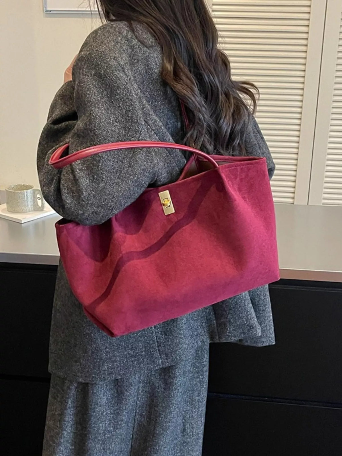 Burgundy suede tote bag with red handles and gold turn-lock clasp