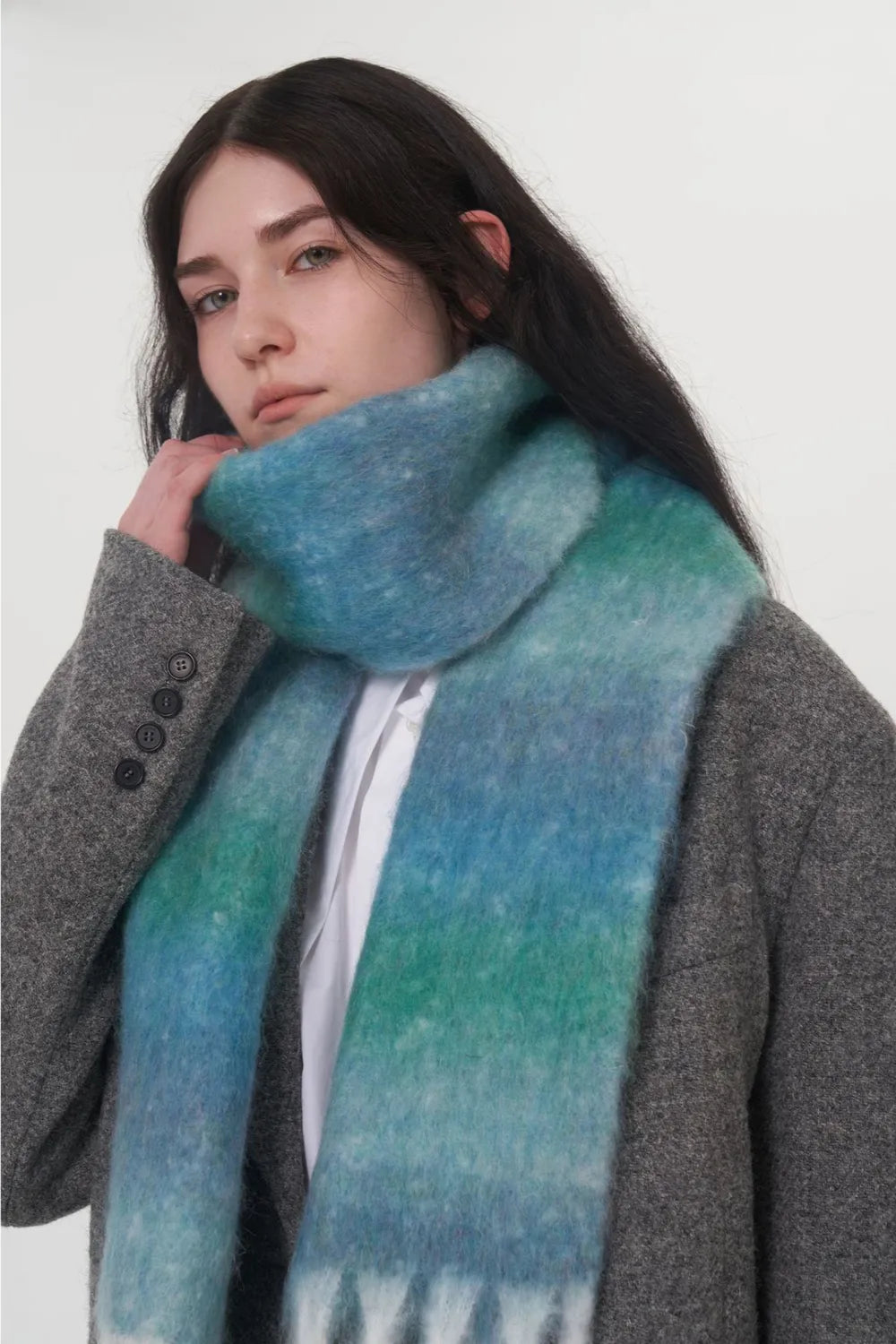 Blue-green gradient thermal scarf with soft fuzzy weave and fringed edge.