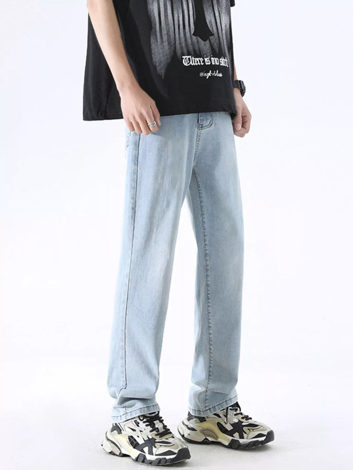 Light blue washed wide-leg stretch jeans on model, relaxed straight fit.