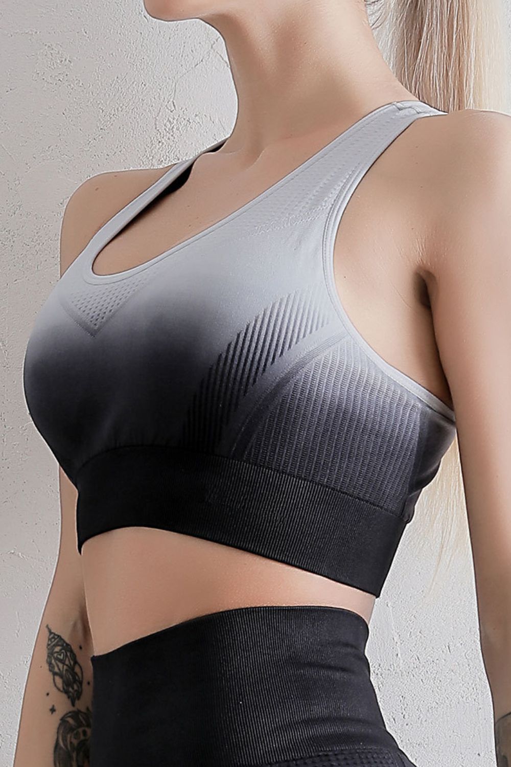 Grey and black gradient racerback sports bra with U-neck front and perforated texture
