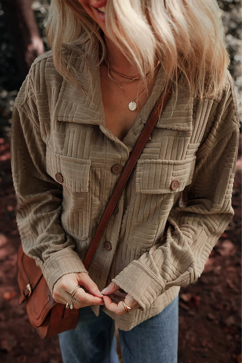 Taupe textured long-sleeve shacket with button placket and flap pockets, close front