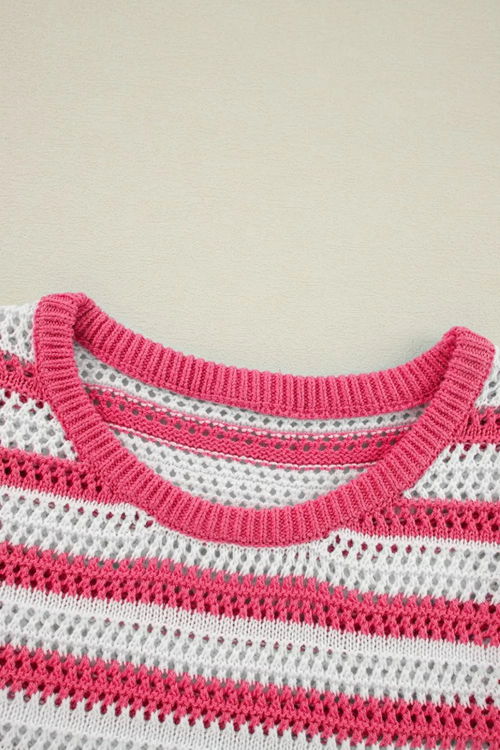 Striped knit sweater dress neckline close-up, strawberry pink and white yarn pattern