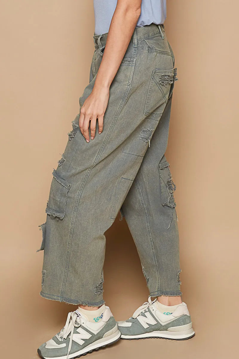 Washed blue denim wide-leg pants with ripped patch pockets and frayed cuffs