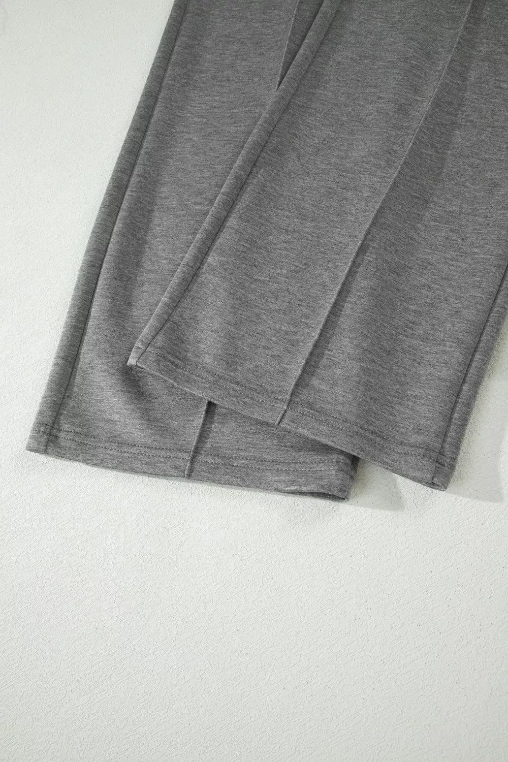 Dark gray casual pants with relaxed fit and hem seam detail