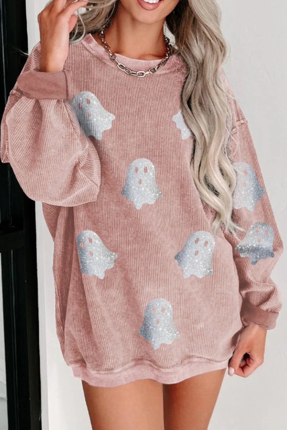 Pale blush oversized crewneck sweatshirt with long sleeves and light-blue ghost print