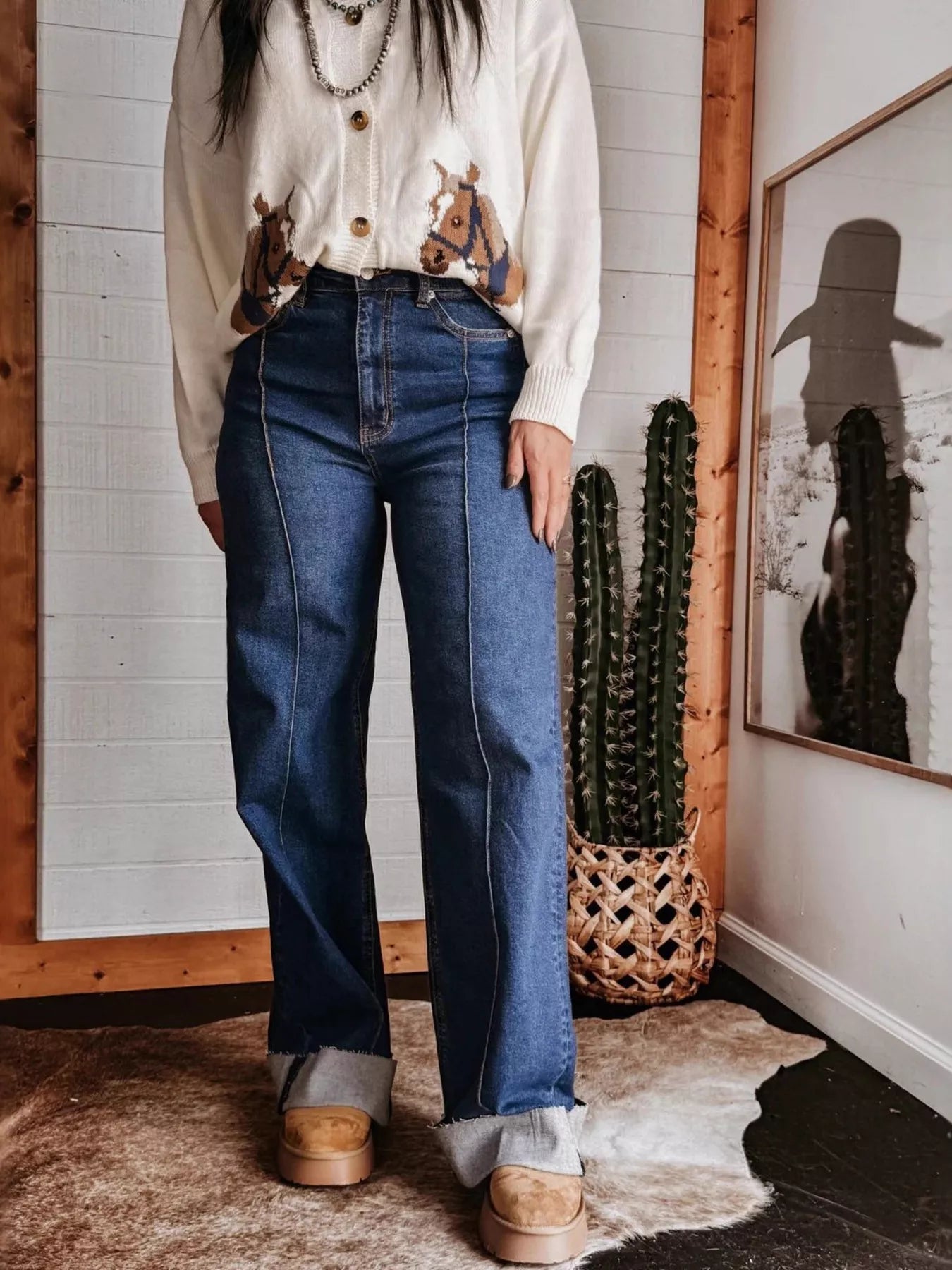 High-waisted wide-leg jeans, medium blue wash, front button and straight wide silhouette