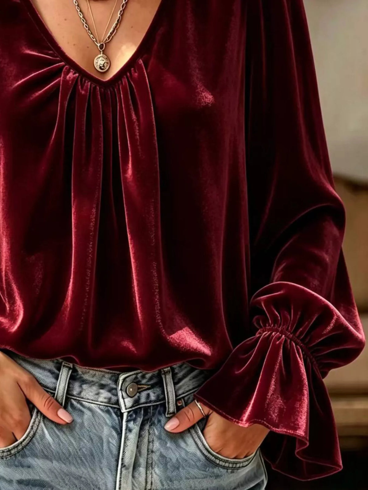 Burgundy satin blouse with V-neck ruching and long gathered flounce cuffs