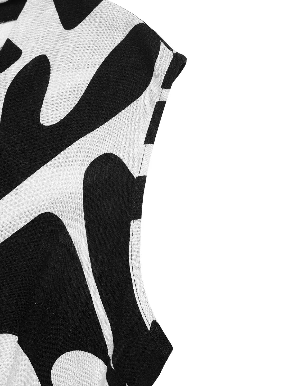 Black-and-white abstract printed fabric close-up, lightweight woven texture.