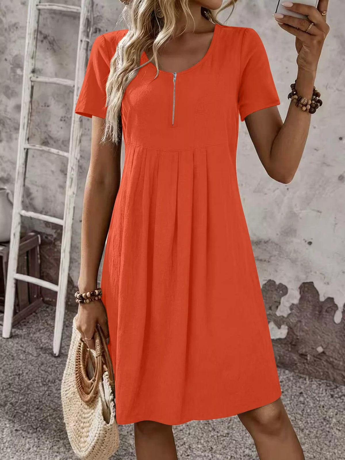 Orange zip-front pleated short-sleeve dress with scoop neckline