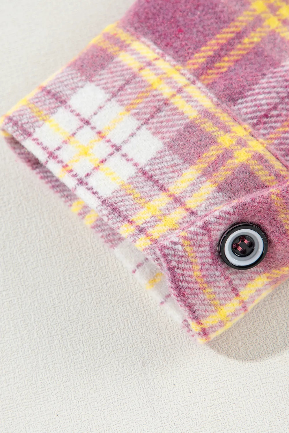 Pink plaid shacket cuff with button and stitched edge