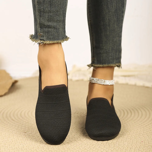 Black knit slip-on loafers, side view with cushioned textured sole