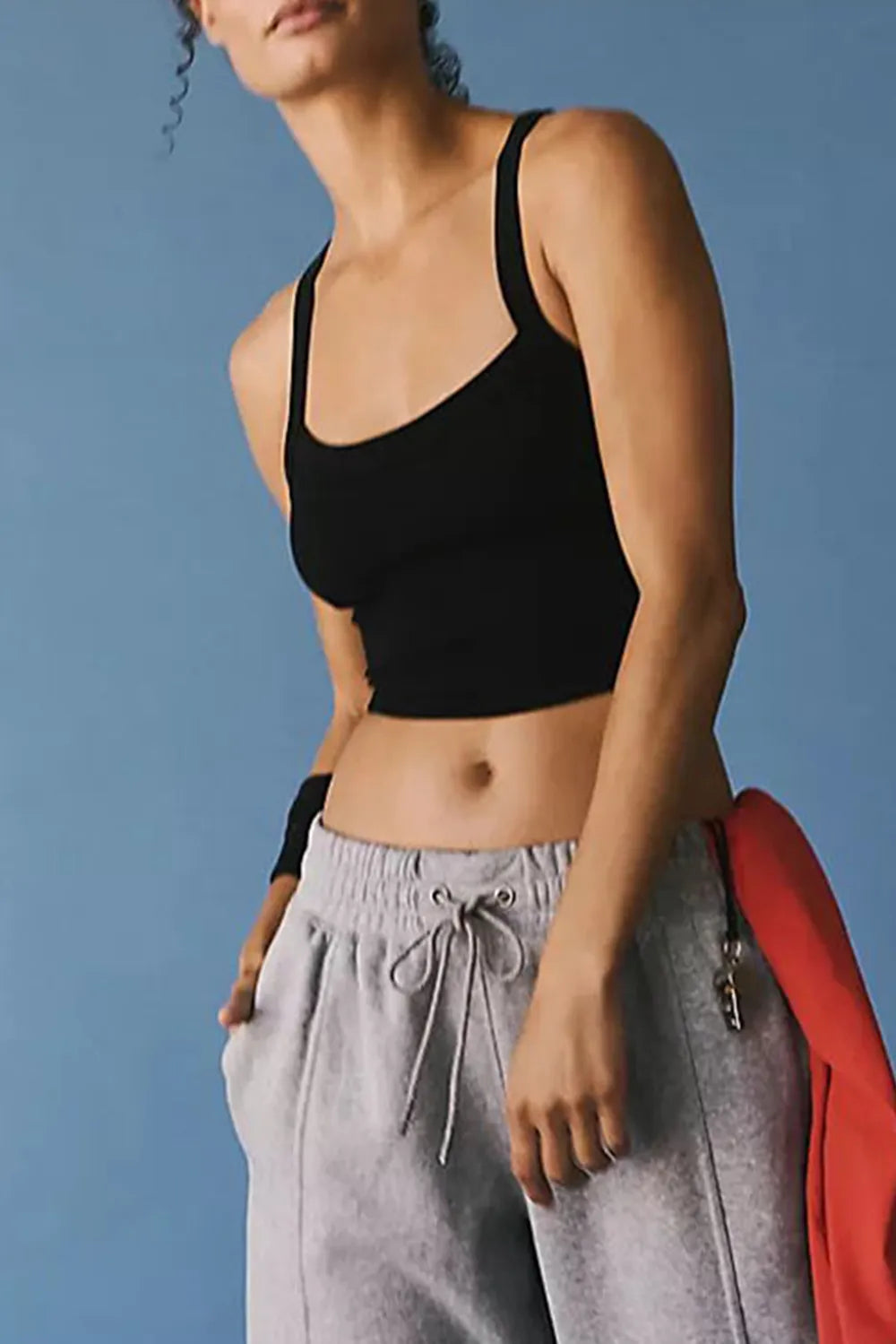 Black scoop-neck athletic tank with thin straps and fitted cropped cut.